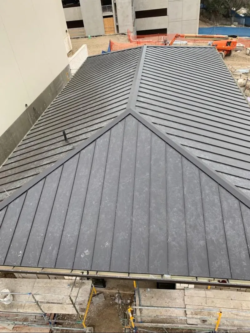 Commercial metal roof construction with crane equipment in Columbus